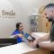 A receptionist assists a patient at Smile by Dr Noura, a trusted dental clinic in Dubai.